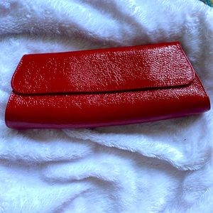 Red patent leather clutch. Jalda